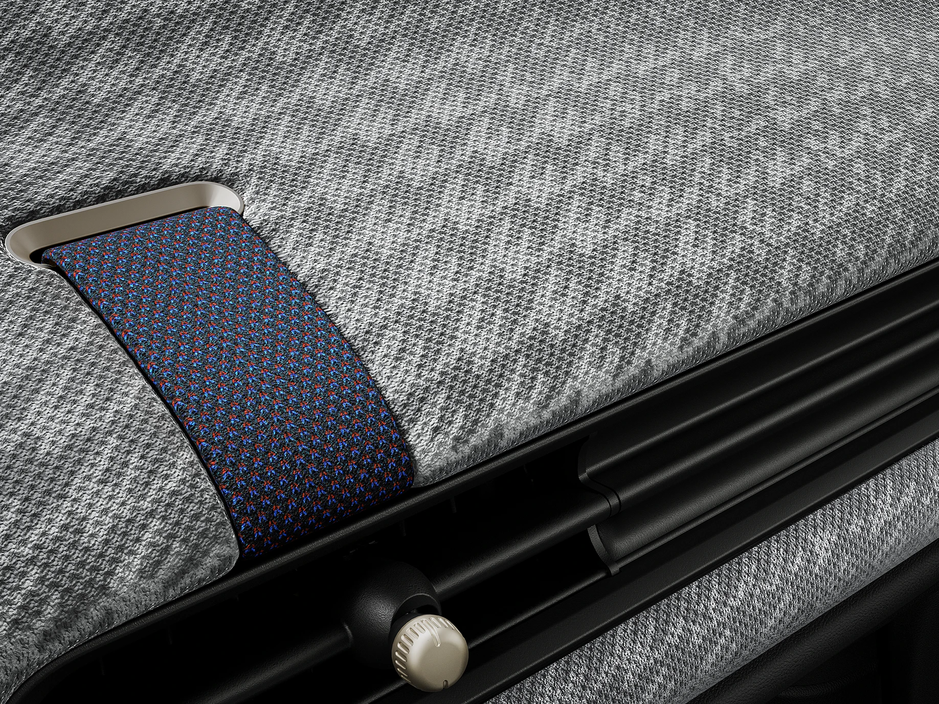 Zbliżenie na deskę rozdzielczą z dzianiny 2D wewnątrz MINI Cooper.