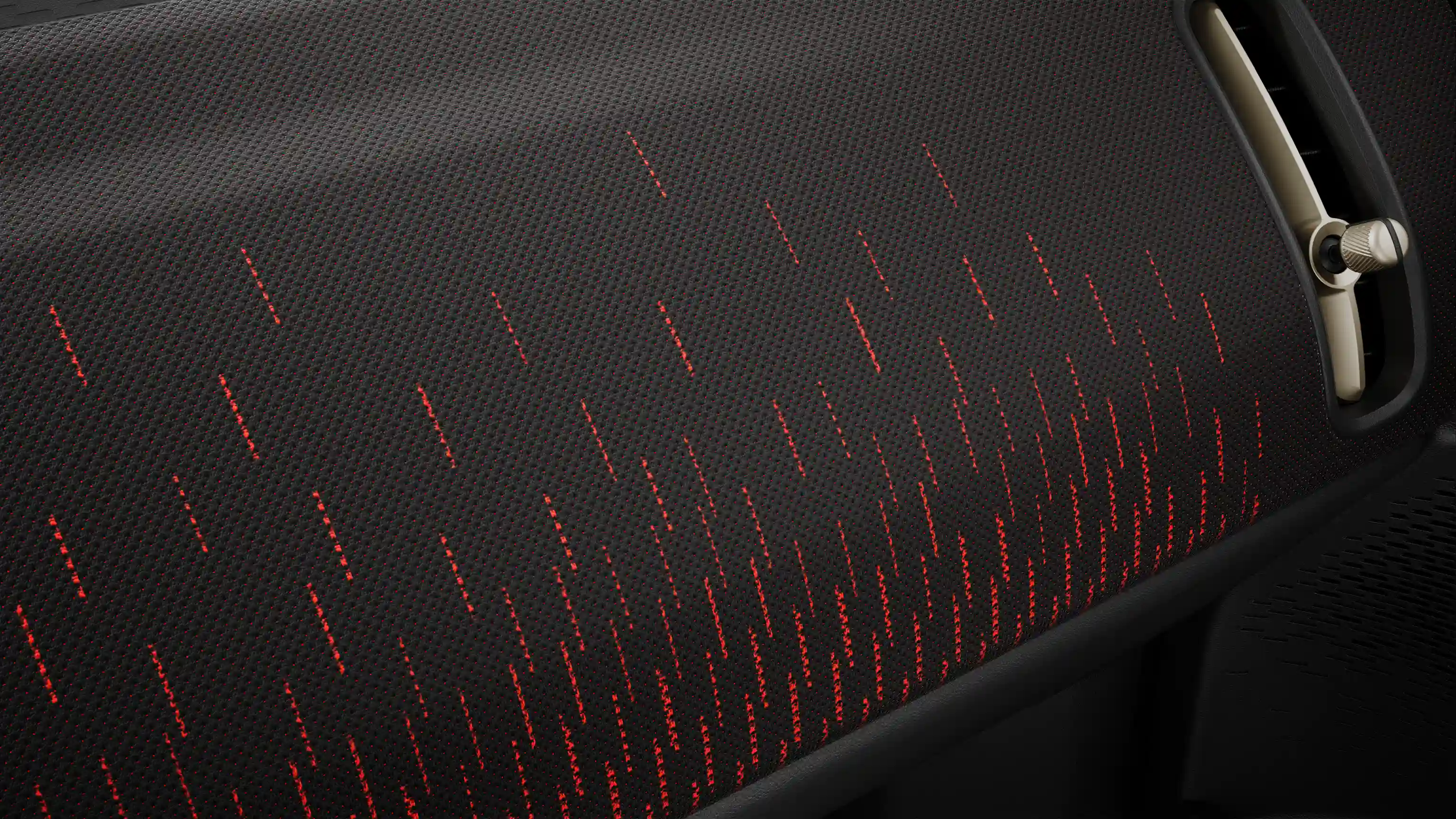 Widok deski rozdzielczej całkowicie elektrycznego MINI Countryman w stylu JCW w kolorach czerwonym i czarnym