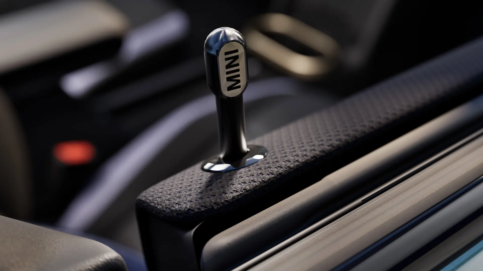 Zbliżenie na oryginalny wewnętrzny sworzeń ryglujący drzwi MINI z czarnego anodowanego aluminium.