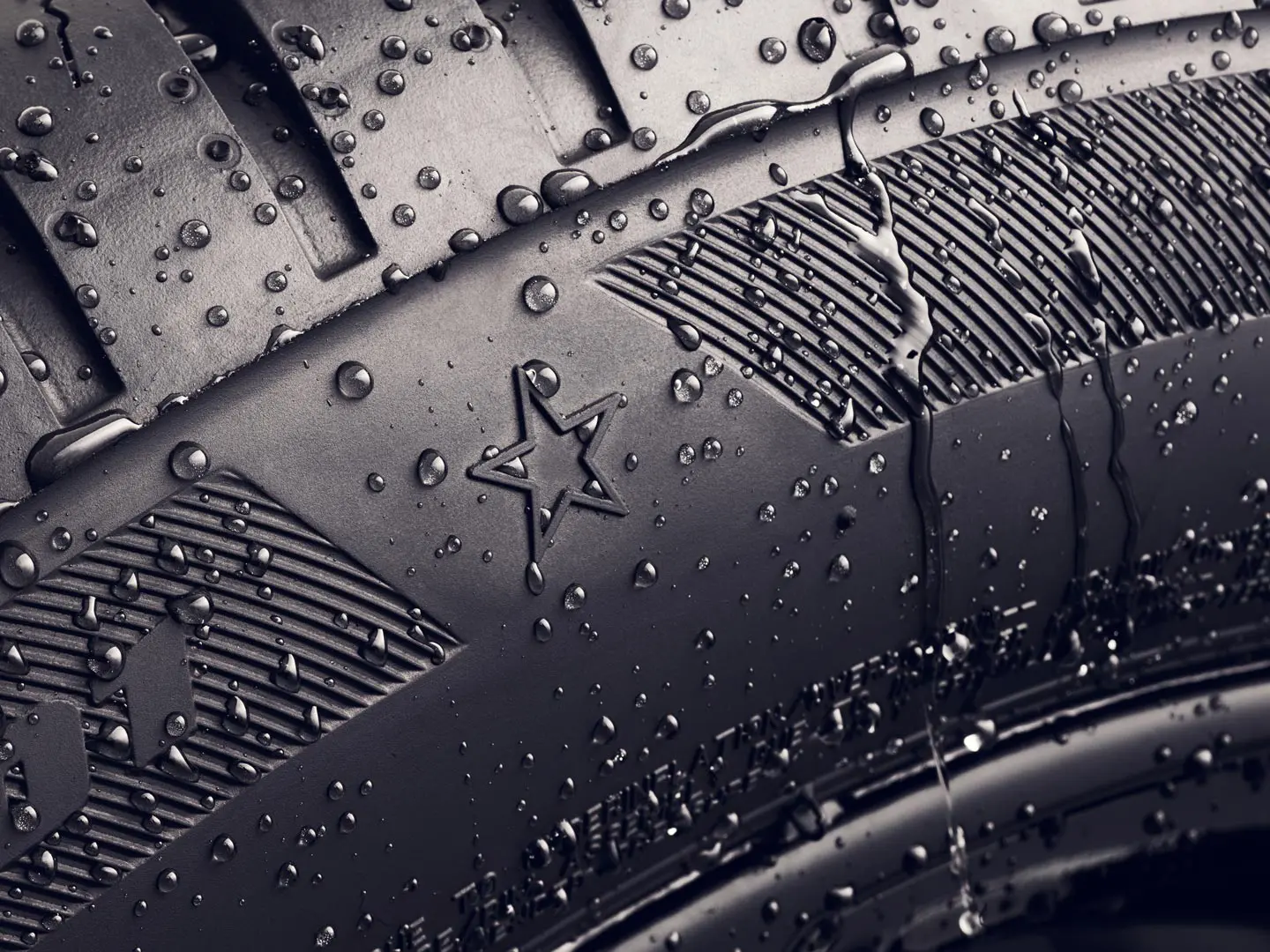 Zbliżenie ścianki bocznej opony z gwiazdką, która wskazuje, że opona ta zapewnia optymalne osiągi w pojazdach MINI. 